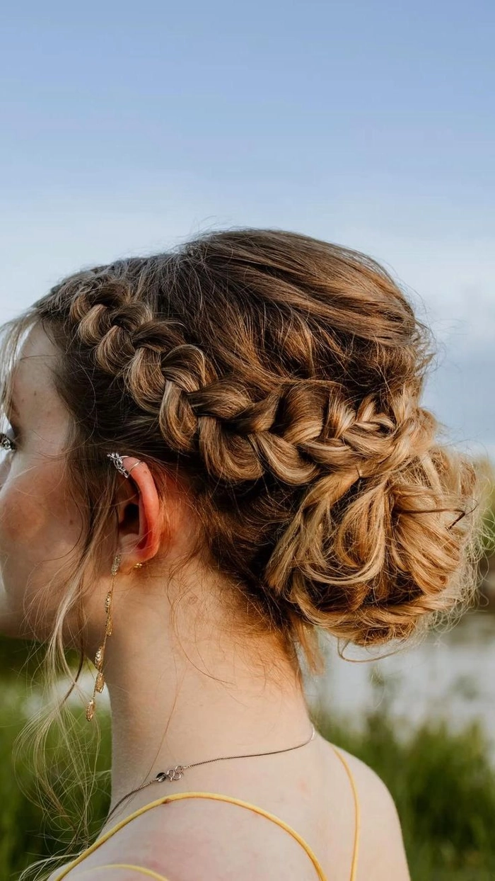 Elegant classic graduation updo with a twisted bun and delicate hairpin details