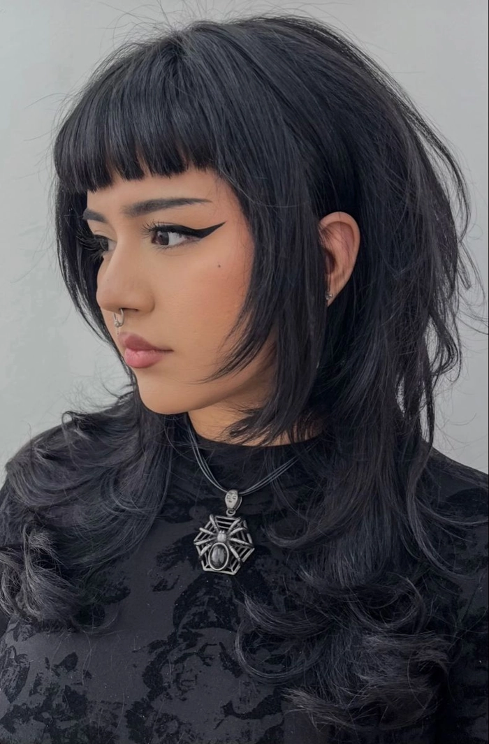 Edgy graduation hairstyle with shaved sides and dramatic textured top for alternative look