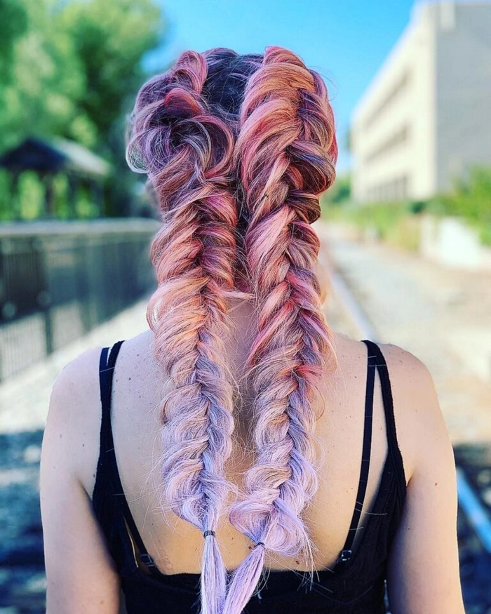 A graduated fishtail braid hairstyle with subtle volume and a side part