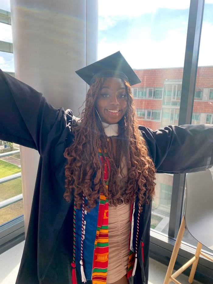 Elegant braided graduation hairstyle with cap for curly hair