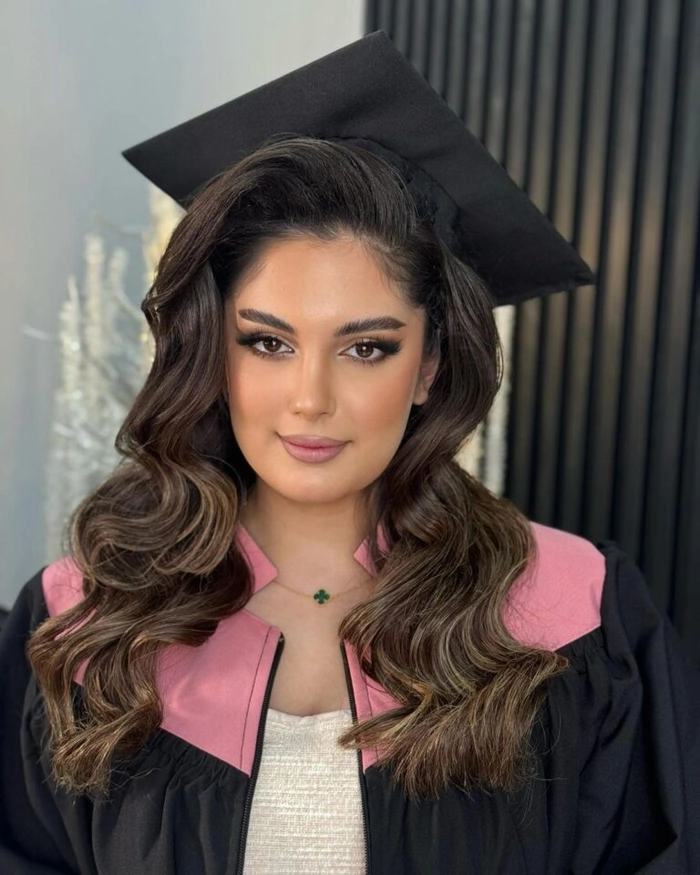 Graduation cap hair framing technique with soft waves and face-framing layers