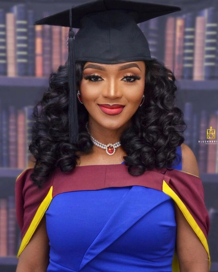 A graduation cap resting on voluminous hair with visible volume-boosting styling techniques