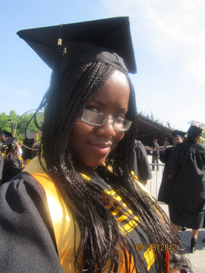 Braided graduation hairstyle under cap with subtle twists
