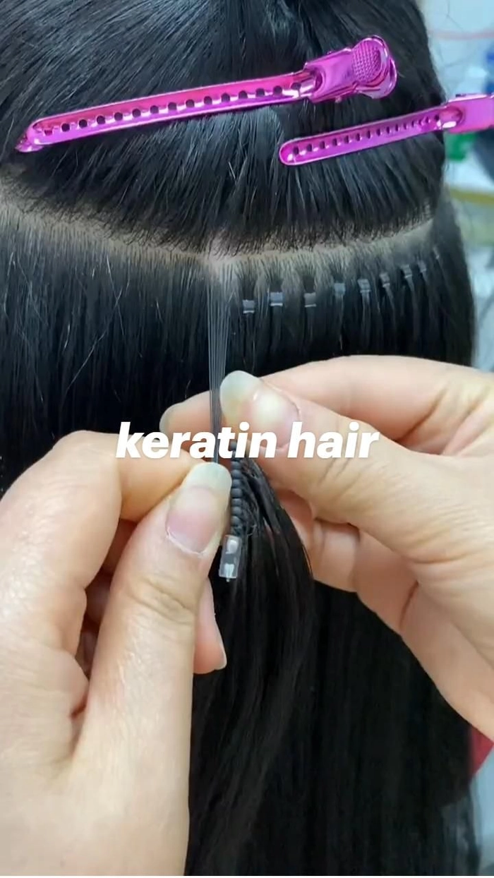 Graduation hair extension blending techniques demonstrated on a glossy, long hairstyle