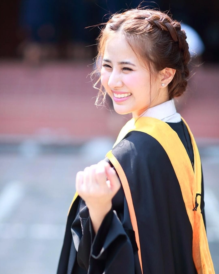 Elegant Asian graduate with sleek straight hairstyle wearing graduation cap