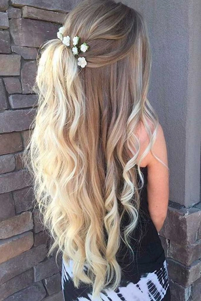 Graduating student with recently dyed hair styled in a soft half-up half-down look