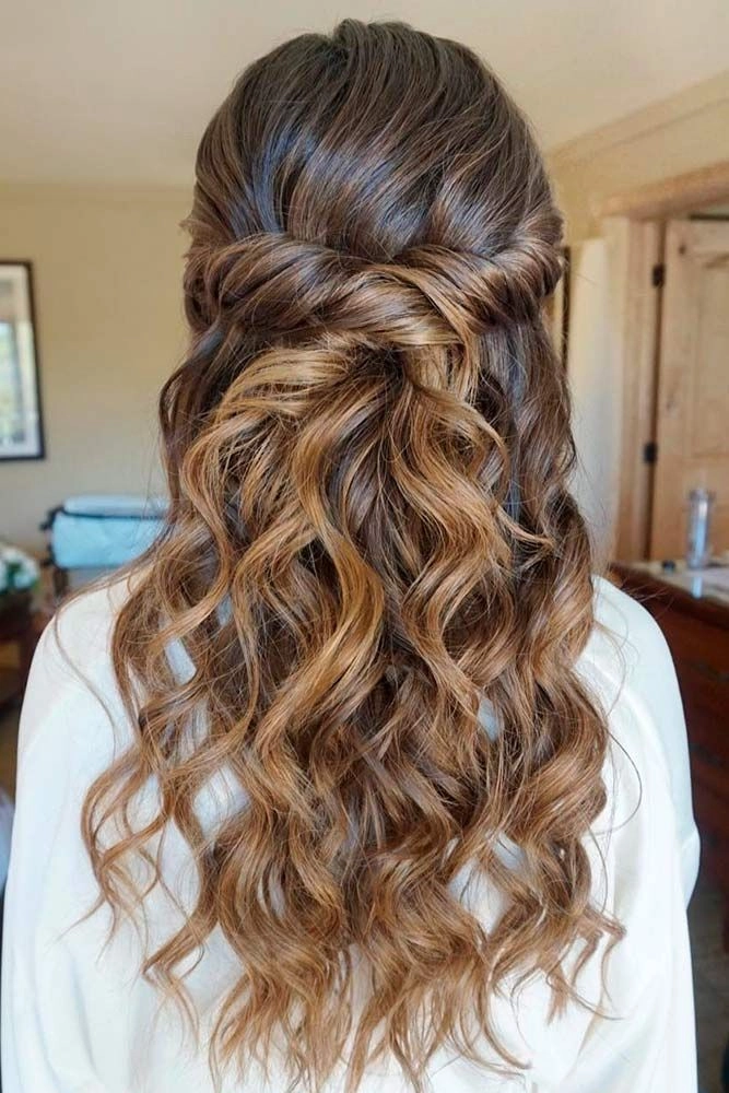 Curly graduation hairstyle with twisted crown and pearl accents Elegant graduation updo for curly hair