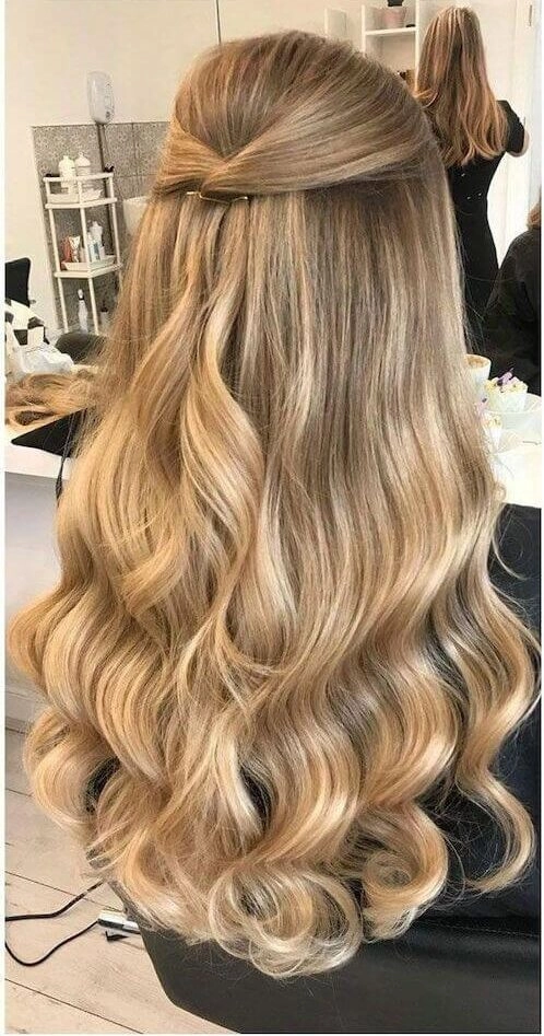 Graduation hairstyle for damaged hair featuring a low bun with soft tendrils