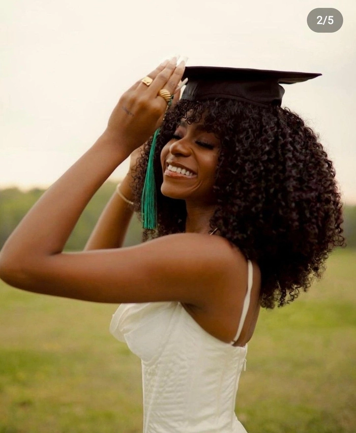 Nursing graduate with a sleek low bun and graduation cap