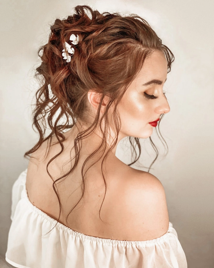 Elegant graduation hairstyle with soft curls to complement an off shoulder gown