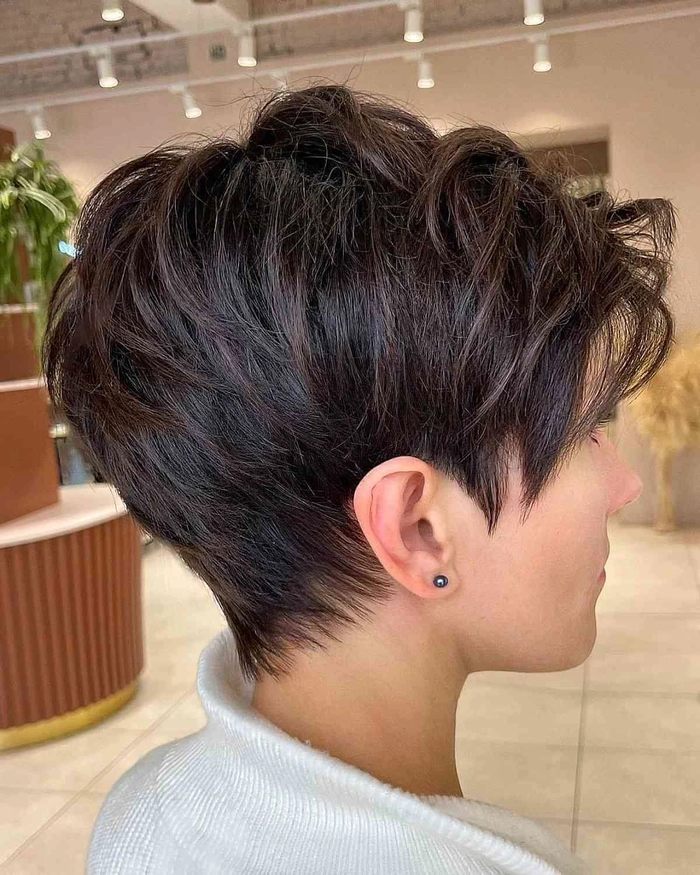 Elegant graduation pixie cut hairstyle with subtle waves and a decorative clip