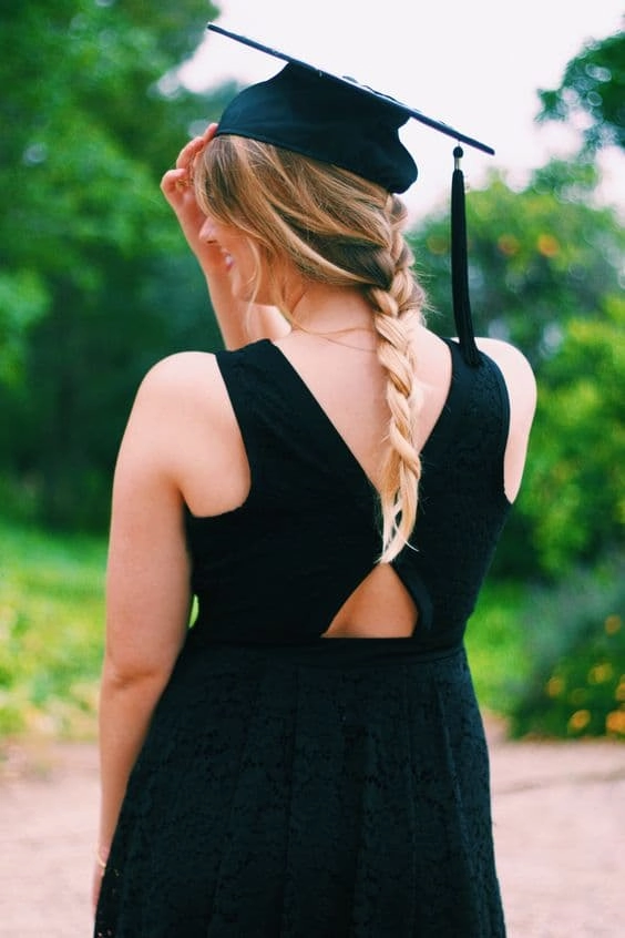 Graduation hairstyle with voluminous waves paired with a V-neck dress for a flattering silhouette