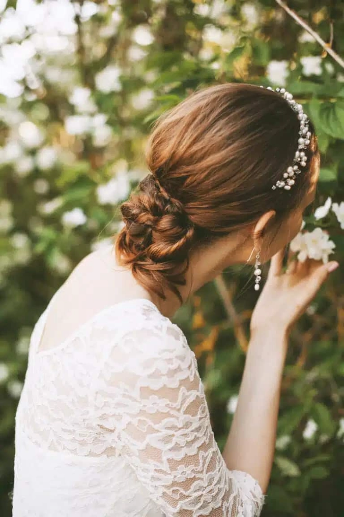 Graduation hairstyle with delicate gold leaf accents for a radiant look