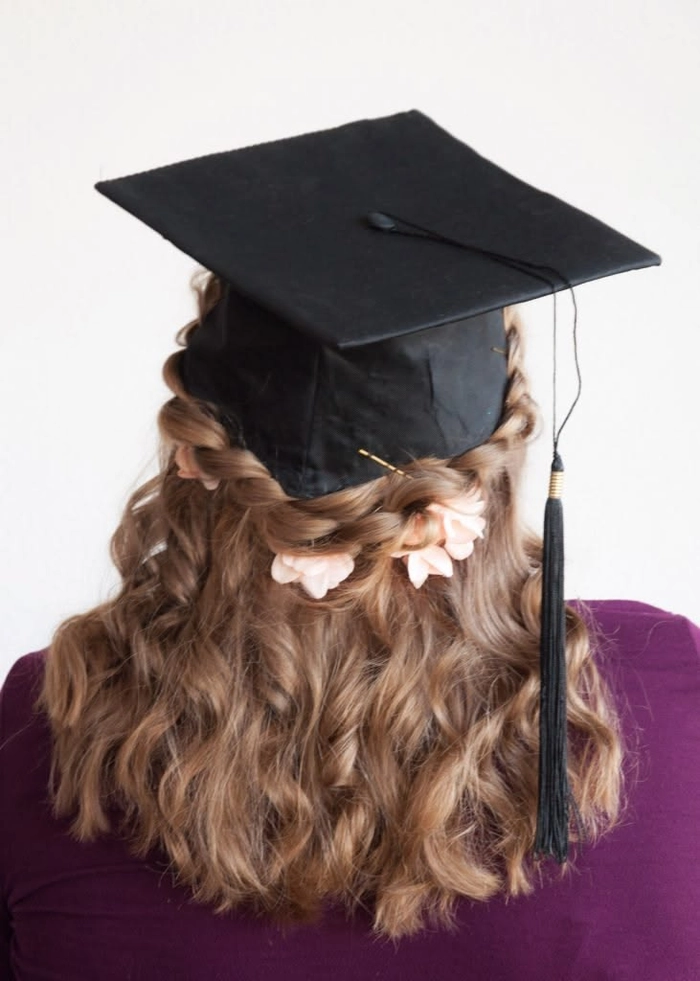 Elegant graduation hairstyle with gold leaf accents and cascading curls