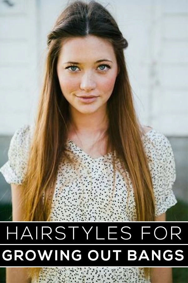 Long layered graduation hairstyle with bangs pinned back elegantly for growing out bangs.