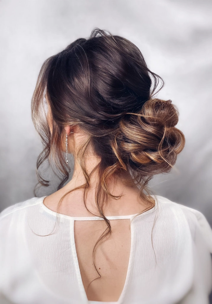 Elegant half-up curly hairstyle paired with a delicate off-shoulder graduation gown