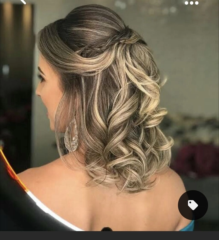 A graduate with an elegant updo hairstyle complements her off shoulder gown