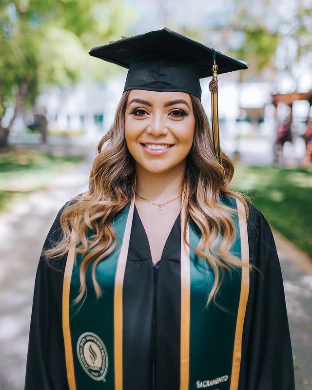 Graduation hairstyle for off shoulder gown featuring a chic half-up half-down style with loose curls and pearl pins
