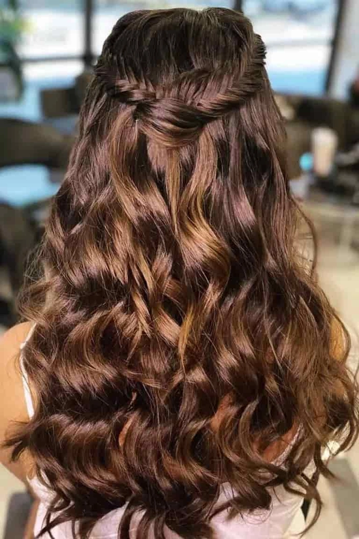 Graduation hairstyle featuring delicate pearl hairpins woven into a chic twisted bun. A graduate showcases her elegant updo accented with pearl hairpins for a classic ceremony look.