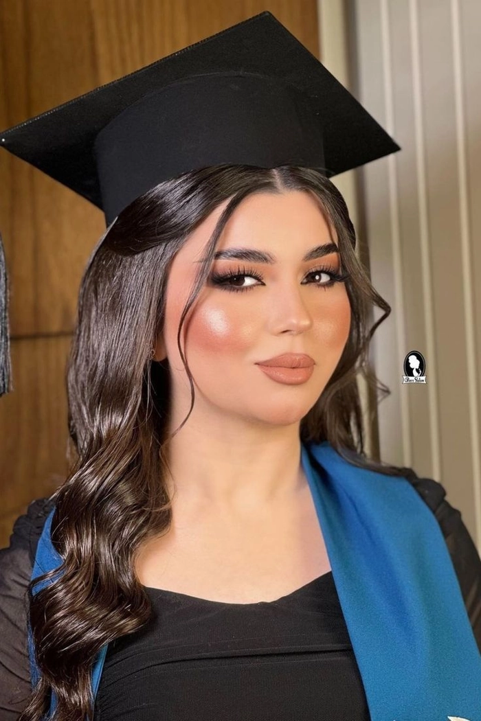 Elegant short graduation hairstyle with soft curls and a small cap