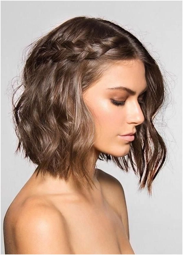 Graduation Hairstyle 6: Layered Shoulder Length Waves for a Flattering Look Shoulder-length layered graduation hairstyle with soft curls and a middle part