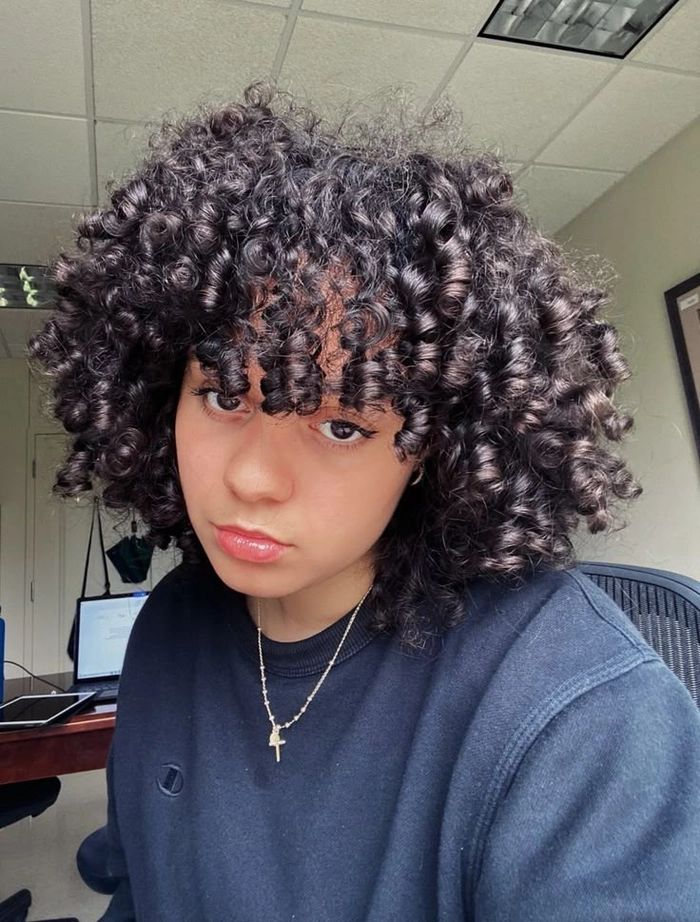 Graduation hairstyle for 3b curls with volume and shine Elegant graduation updo showcasing defined type 3b curls