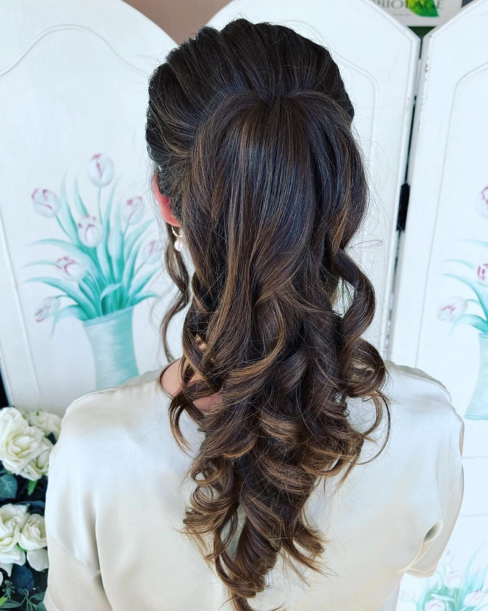 Elegant side-swept graduation hairstyle complementing a v-neck dress