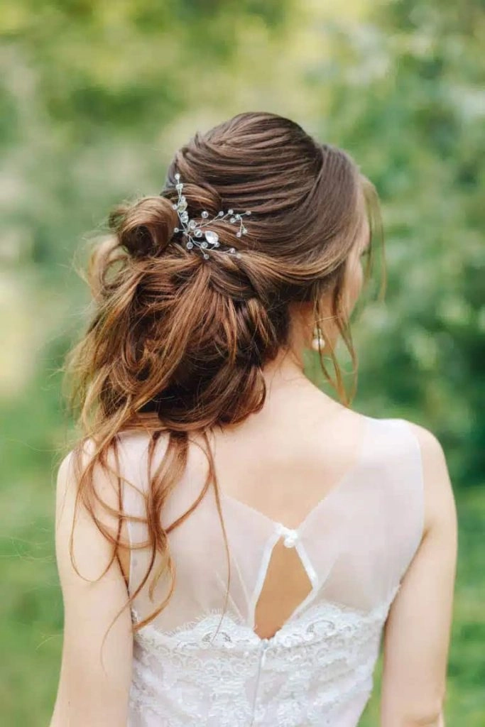 Graduation hairstyle adorned with sparkling crystal clips for a chic and elegant look