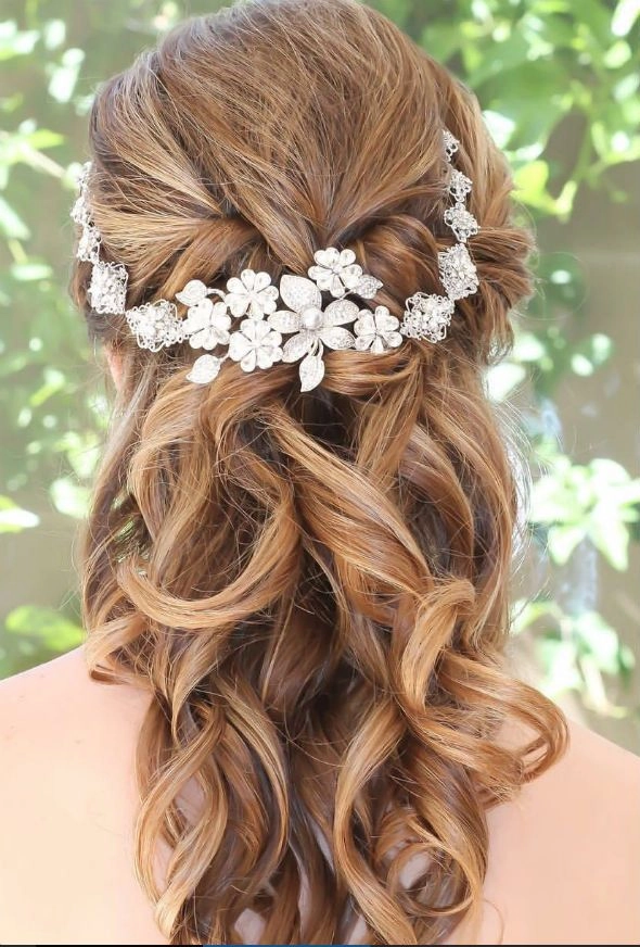 Graduation Hairstyle 9 - Romantic updo with floral accents Elegant graduation hairstyle with white flowers and soft curls