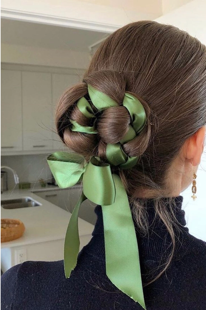 Stylish graduation updos with delicate ribbon details Graduation hairstyle with colorful ribbons adding a celebratory touch