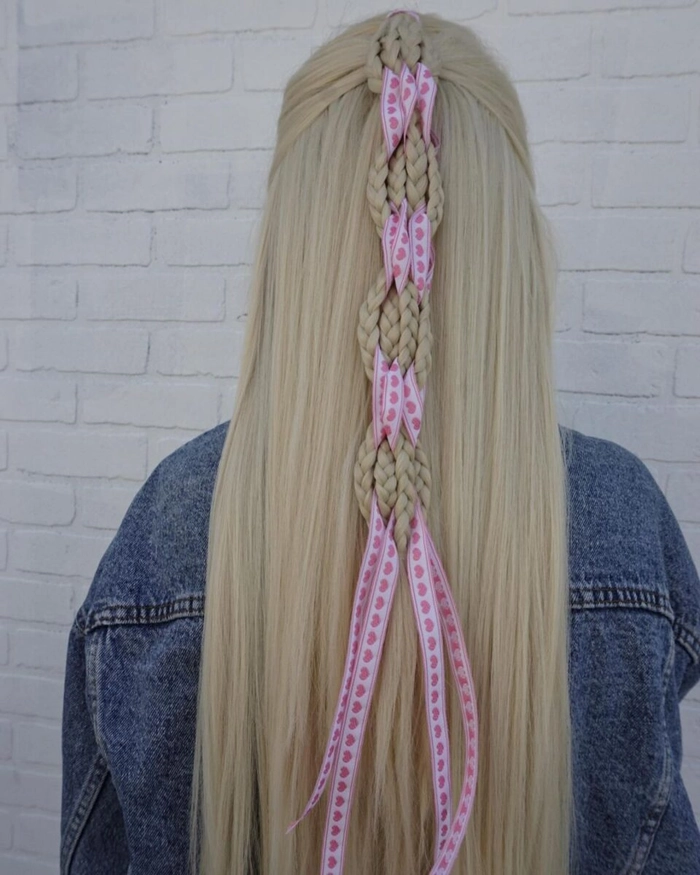 Elegant graduation updo with woven ribbon accent Graduation hairstyle with ribbon bow and curled ends