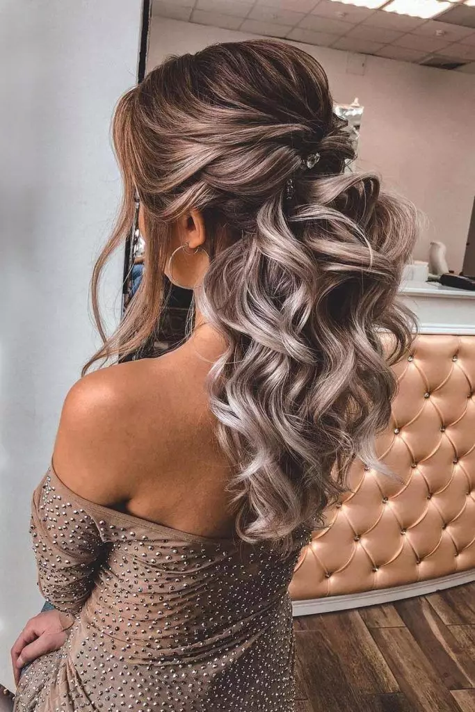 Chic Half-Up Waves Graduation Hairstyle Graduation cap settled over a chic half-up hairstyle with loose waves