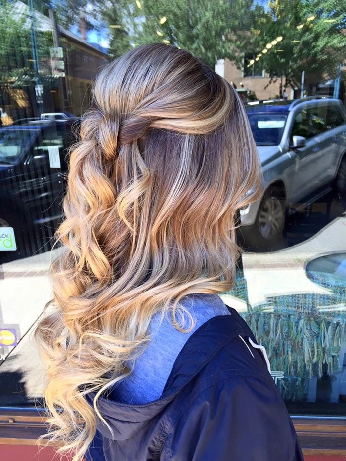 Elegant half up half down graduation hairstyle with soft flowing curls
