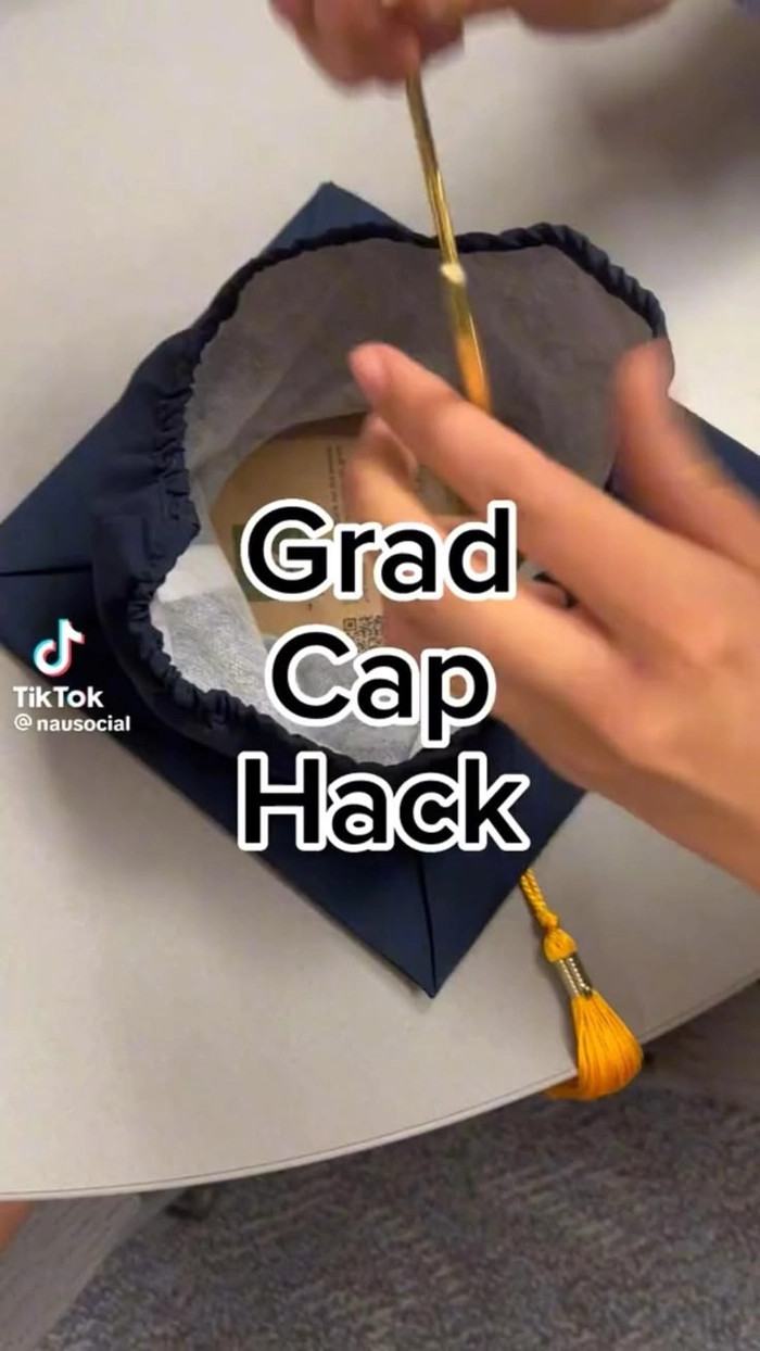 Side view of a graduation cap revealing bobby pins hidden underneath to secure the hairstyle