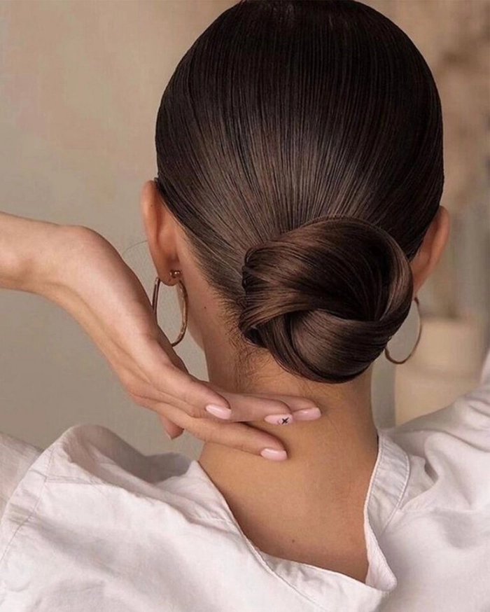 High bun placement for graduation cap with sleek finish