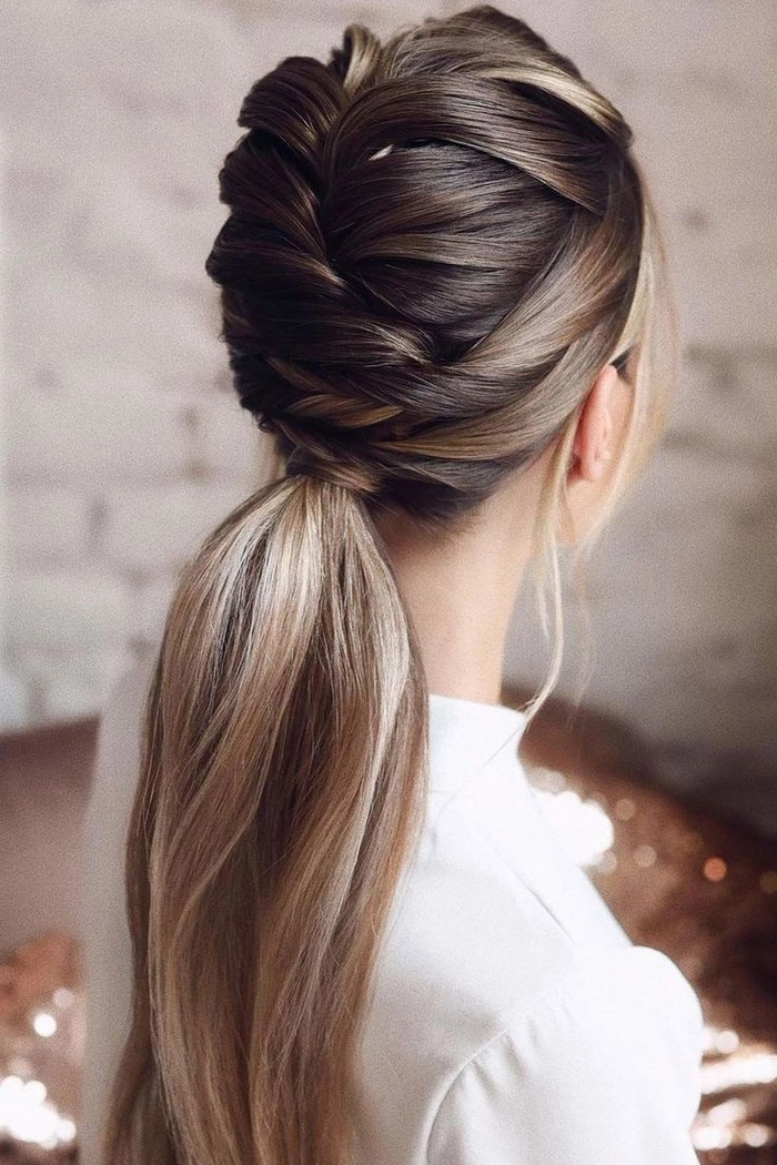 Elegant high ponytail graduation hairstyle with volume at the crown and soft waves