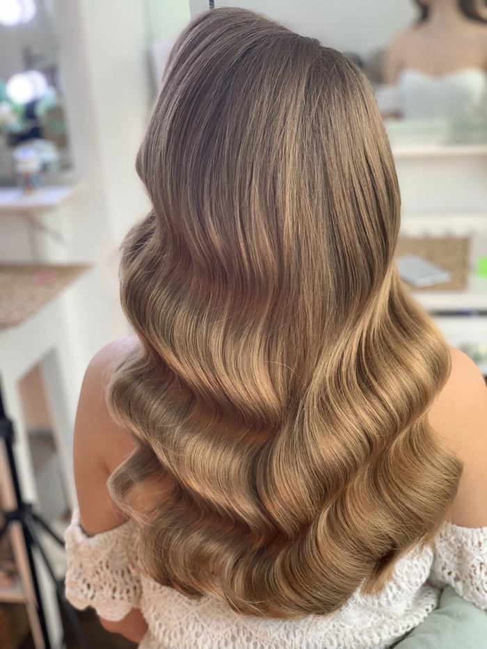 Hollywood waves graduation hairstyle with soft cascading curls