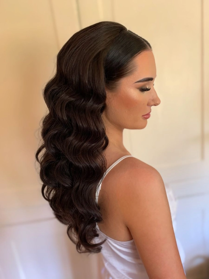 Hollywood waves graduation hairstyle with smooth voluminous curls and a shiny finish
