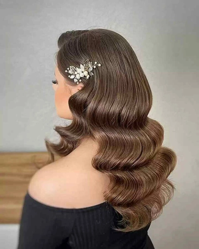 Hollywood waves graduation hairstyle with elegant curls cascading over shoulders