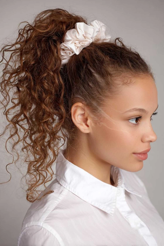 Graduate wearing a humidity-proof braided updo with decorative clips