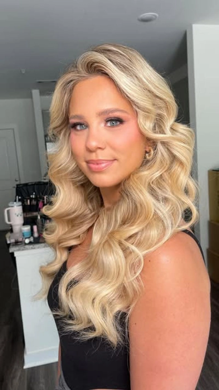 Graduation hairstyle with romantic loose curls cascading over shoulders