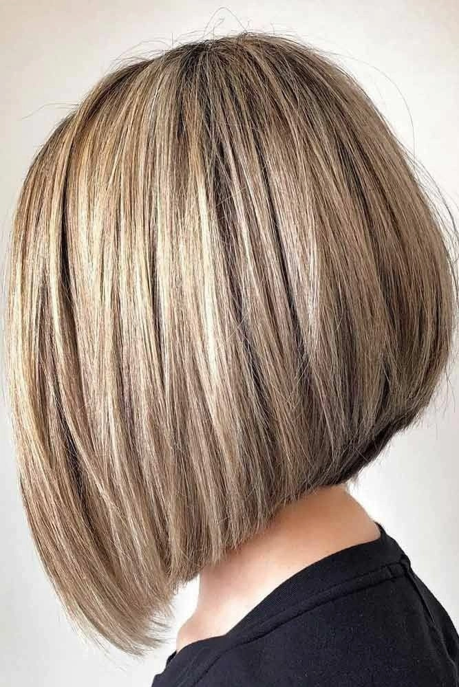 Elegant graduation hairstyles for blunt bob cuts with a sleek, modern look A graduate with a blunt bob hairstyle and her cap angled, featuring graduation hairstyles for blunt bob cuts