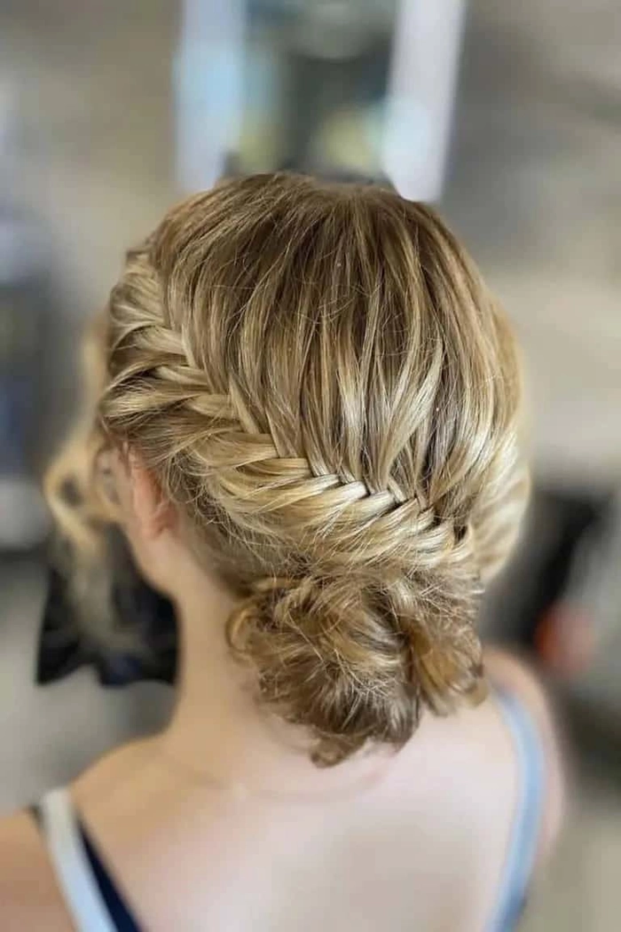 Elegant Asian graduate with sleek low bun and glossy straight hair
