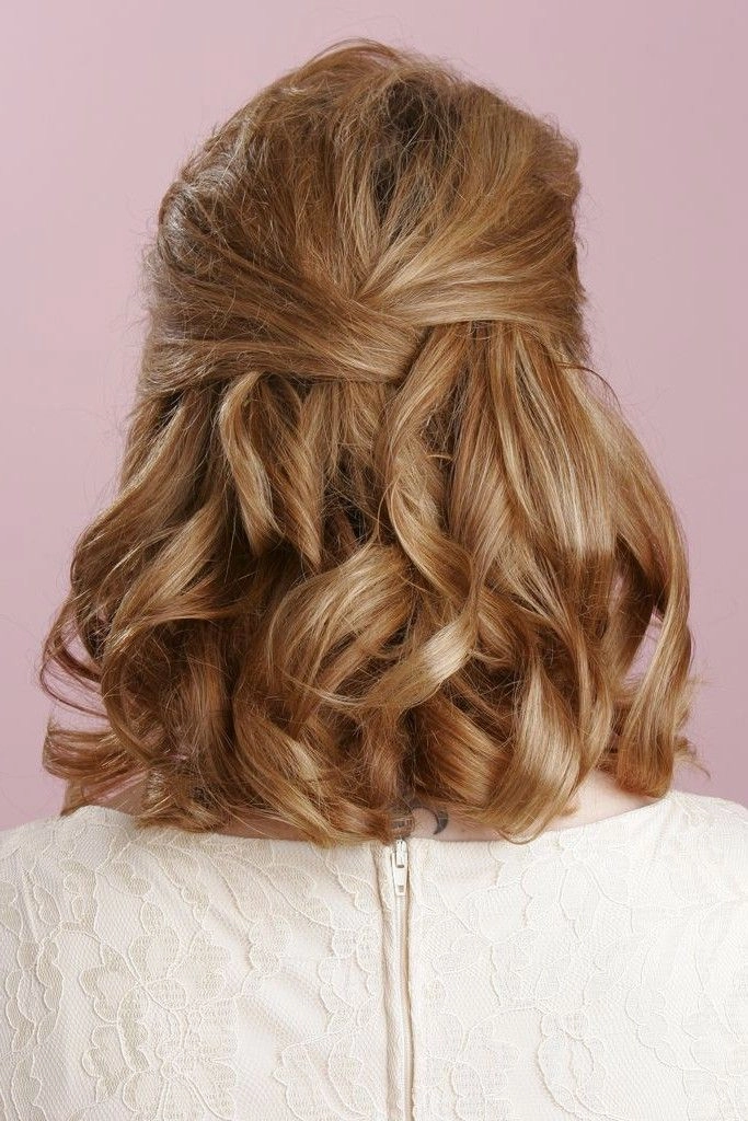 Shoulder-length layers graduation hairstyle with cap and gown Graduate with shoulder-length layered hair styled for her graduation ceremony