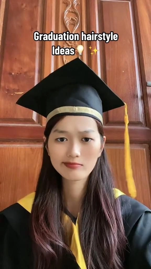 Latina graduation hairstyle with cascading curls and a sleek side part Graduation hairstyle for Latina hair featuring soft waves and a decorative hairpin