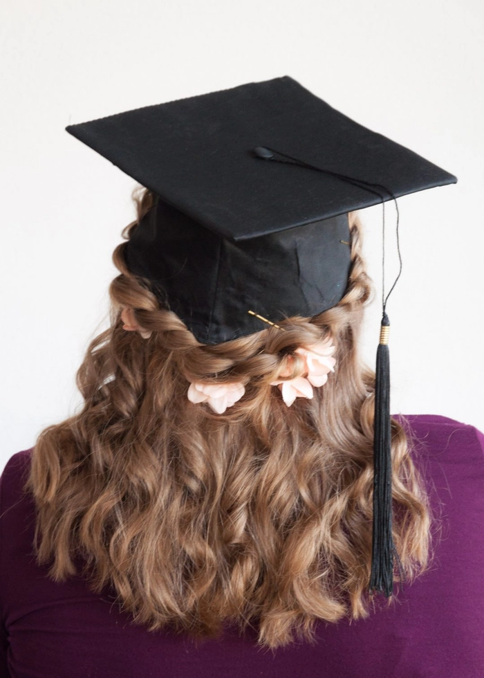 Elegant low bun hairstyle perfectly styled to fit under a graduation cap