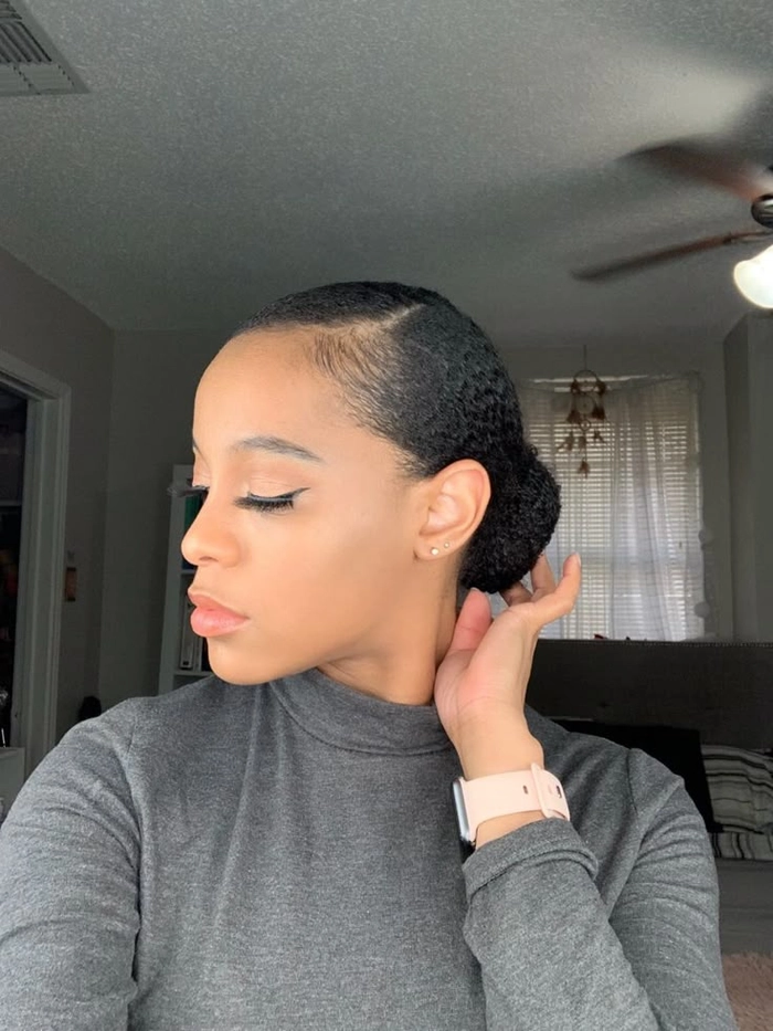 Low bun hairstyle tucked under graduation cap with elegant side part