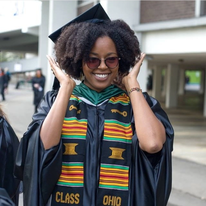 Graduate with natural hair under graduation cap