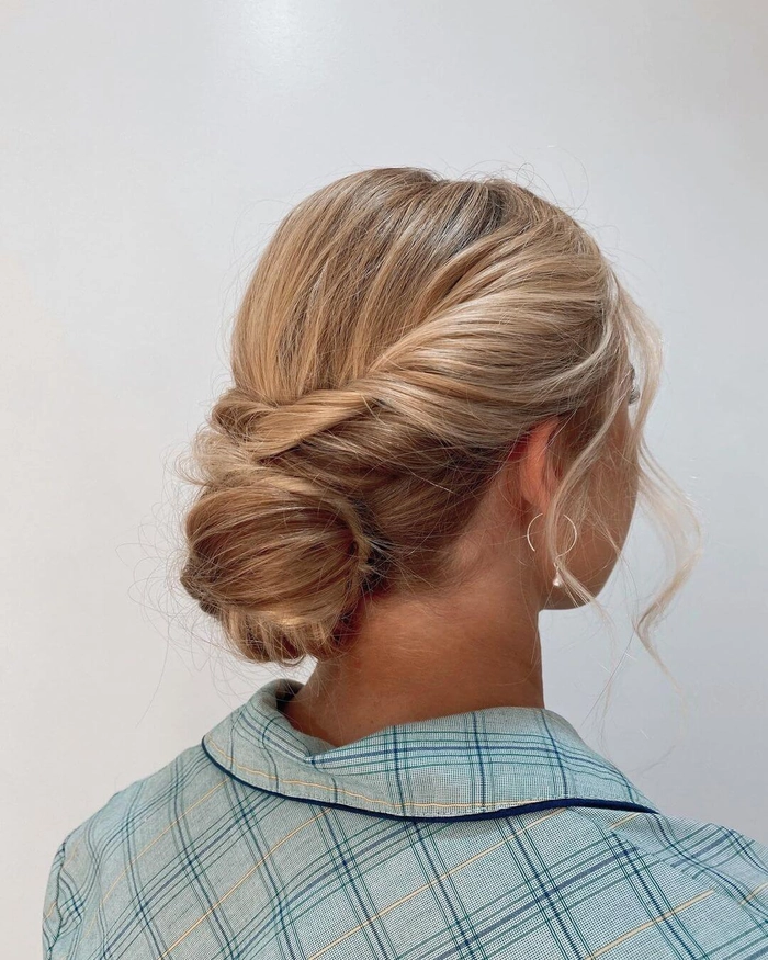 Professional graduation hairstyle with a sleek low bun for corporate workplace A polished low bun graduation hairstyle ideal for corporate job interviews