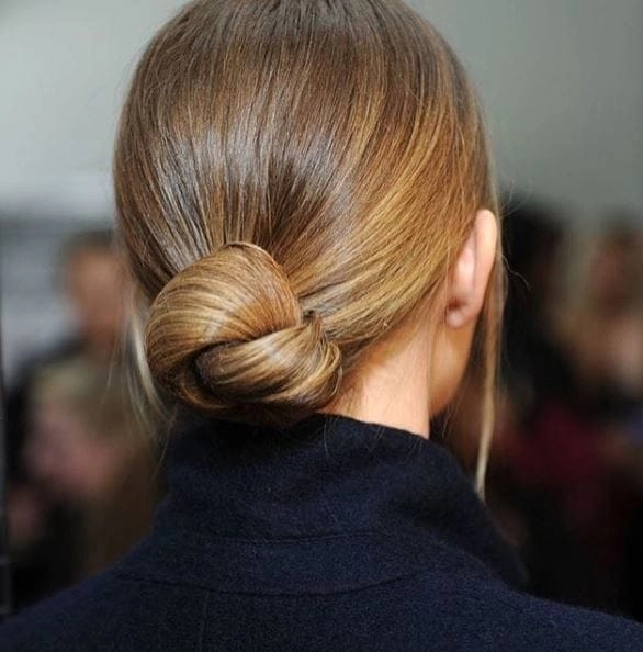 Professional graduation hairstyle with smooth low bun for office ready look A sleek low bun graduation hairstyle suitable for corporate job interviews